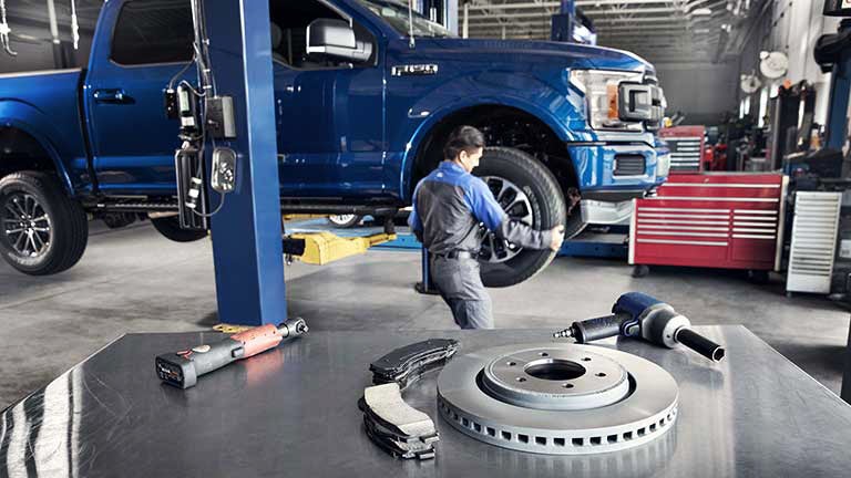 Mechanic fixing tire | Harbin Motor Company in Scottsboro AL